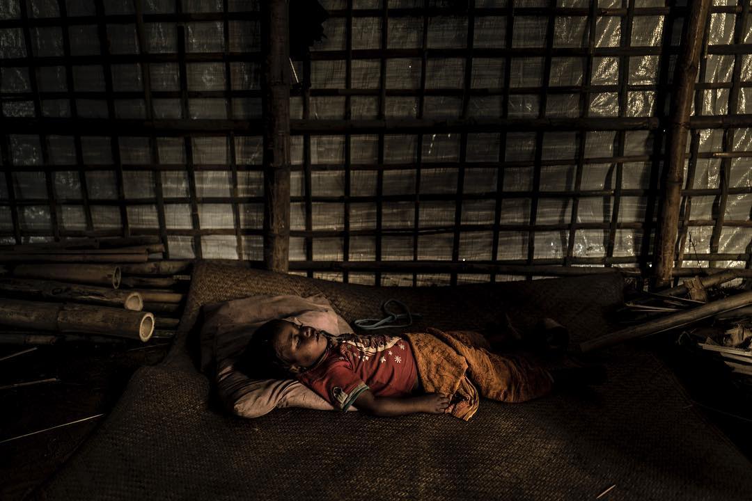 A Rohingyan girl sleeps inside her familys new makeshift shelter in Kutupalong refugeecamp
