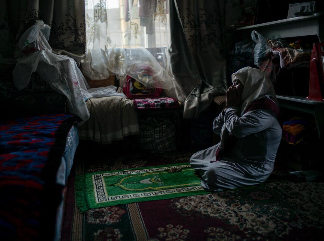 A Kyrgyz woman prays in her home  early morning. Reportage on interval displaced familys for @noedhjaelp back in 2014