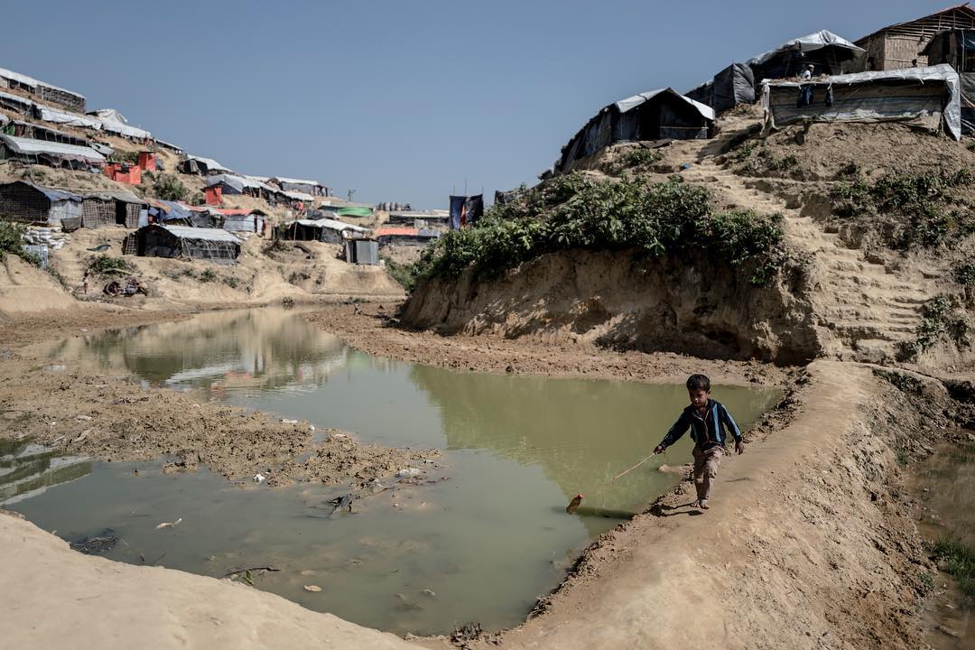 A Rohingyan child plays in the muddy pits at Kutupalong refugee camp
